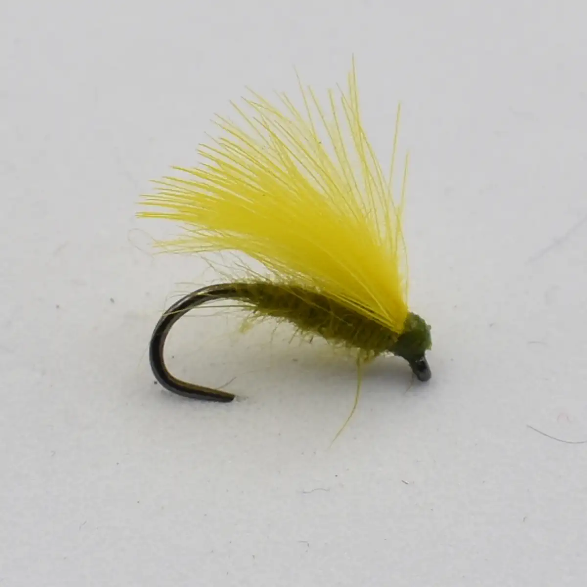Yellow dry-fly fishing lure with a bright hackle atop a dark curved hook, used to imitate insects on the water surface.