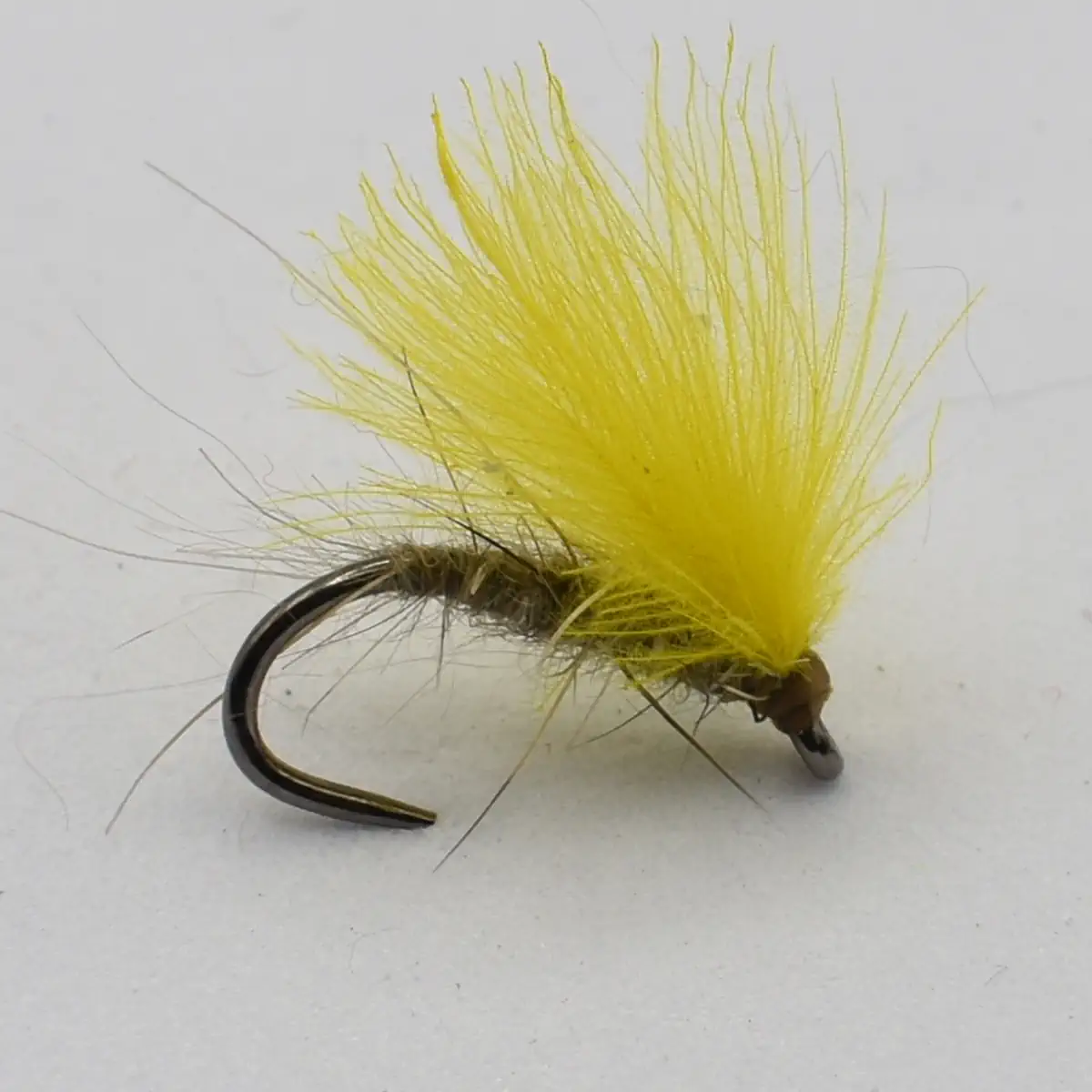 Fly fishing lure: curved hook with bright yellow marabou feathers (fuzzy streamer).