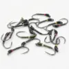 Assorted metal fishing lures resembling worm-like jigs with black striped bodies and colored band markers on a white surface.