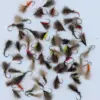 Assorted fishing flies with fluffy marabou and metallic accents laid out on a white background (fly types for trout).