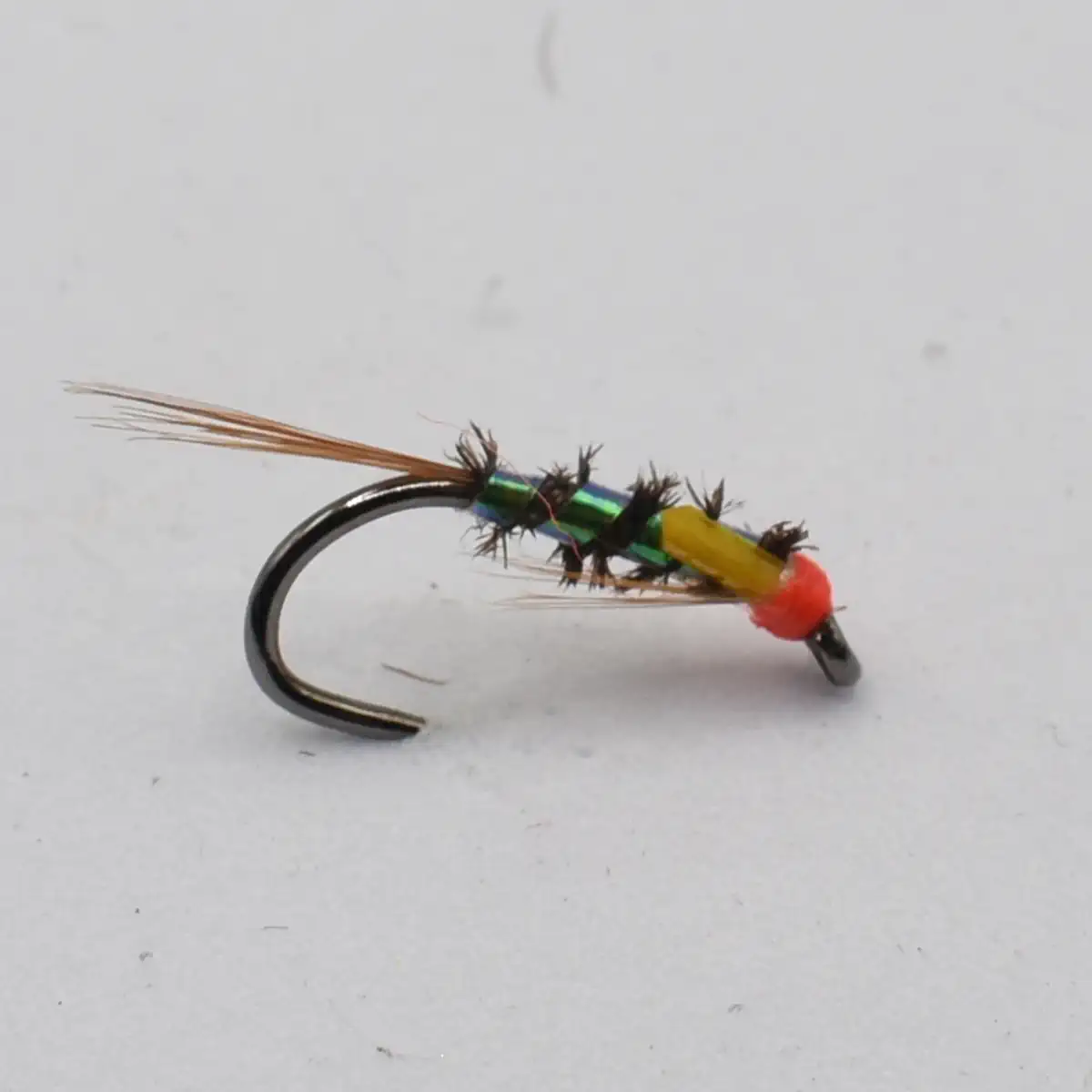 Colorful fishing fly lure with a black hook, green body, yellow bead, and orange head and tail feathers to attract fish.