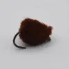 Brown fuzzy fishing lure with a curved hook, resembling a pom-pom jig.