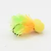Fishing lure with a bright yellow foam head and lime-green/orange feathered skirt.