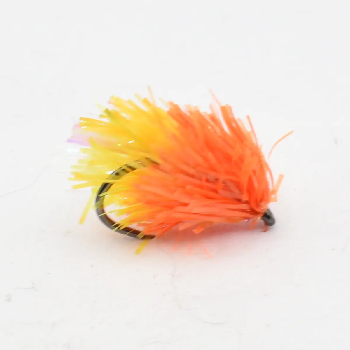 Bright orange-yellow streamer fishing fly with a curved hook and fluffy synthetic hackle. Used to attract fish in freshwater or saltwater.