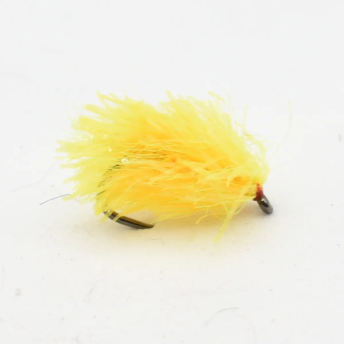 Bright yellow fuzzy fishing lure (fly) with a hook, used to attract fish on a fishing line.