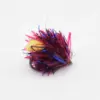 Colorful fishing lure with pink, red, and blue tinsel strands and a small hook visible.