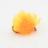 Bright orange fuzzy fishing lure (fly) with a dark hook partly visible, used to attract fish in fishing.