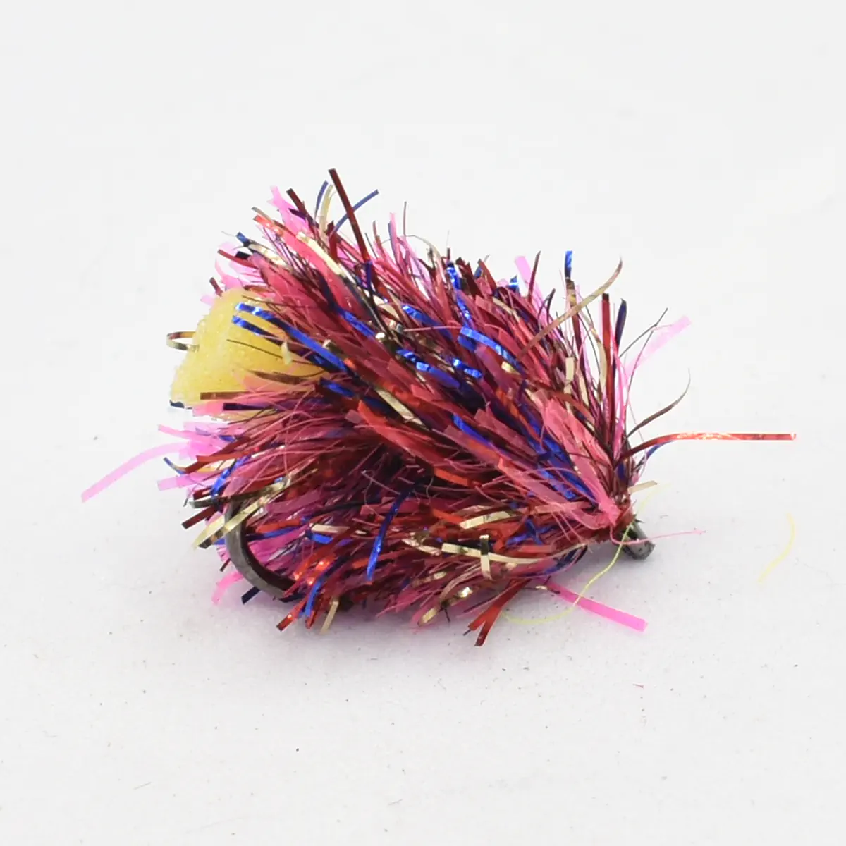 Colorful metallic tinsel pom-pom with pink, purple, and blue strands on a small ring-like base.