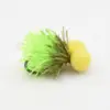 Neon green fishing jig with a fluffy skirt and two yellow foam ball heads on a white surface