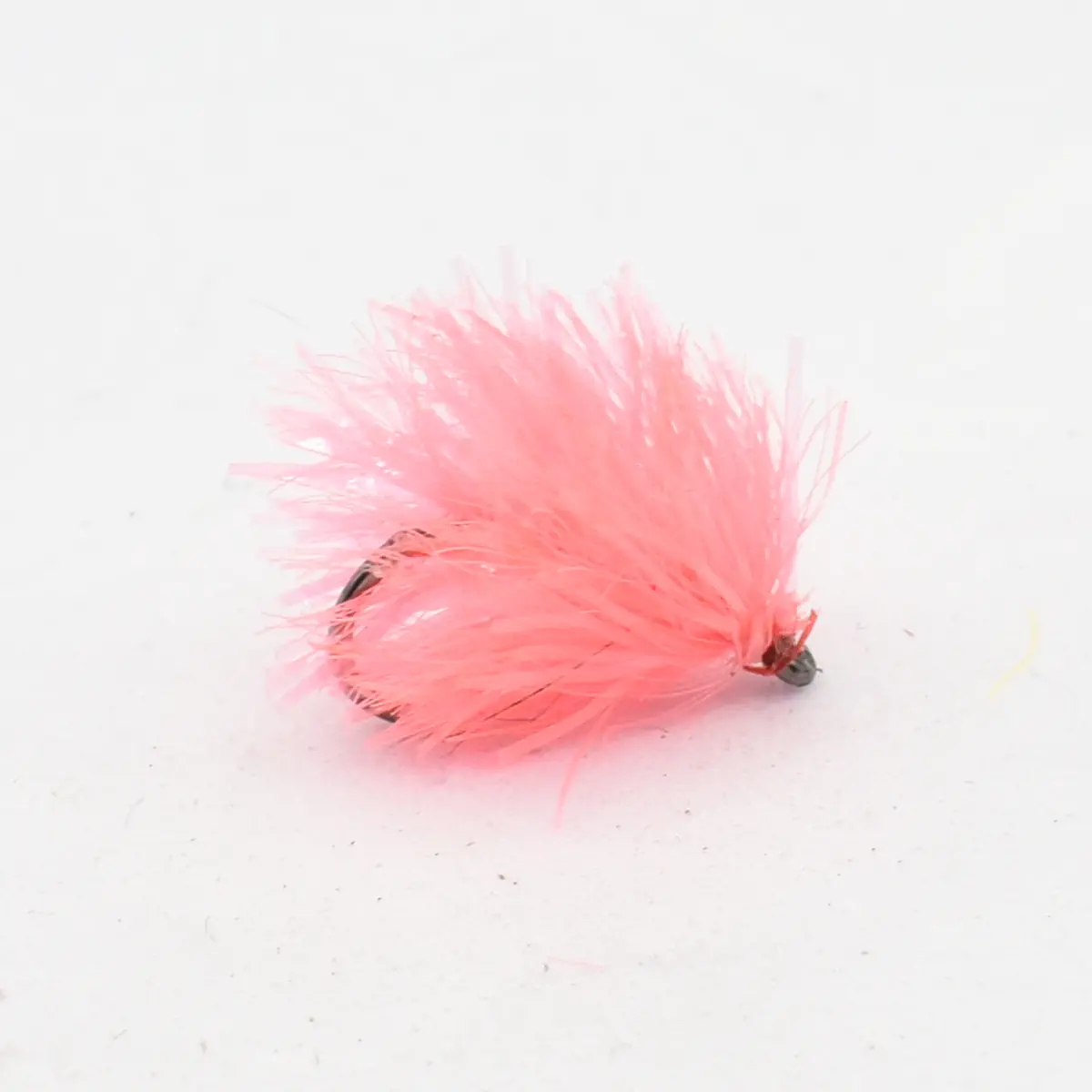 Pink feathered fishing lure with a small hook, used for trout fishing.