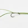 Close-up of a metal fishing hook tied to a green line with thread wraps around the eyelet edge.