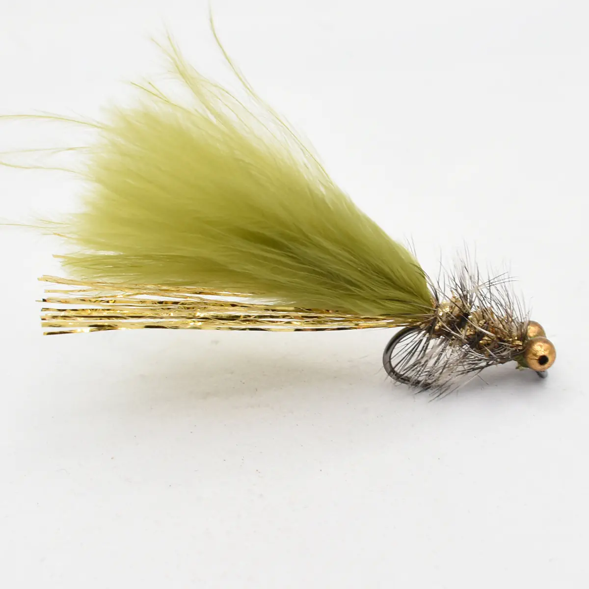 Orange-yellow olive dry fishing fly with feather tail and hackle, used for trout fishing on a white background.