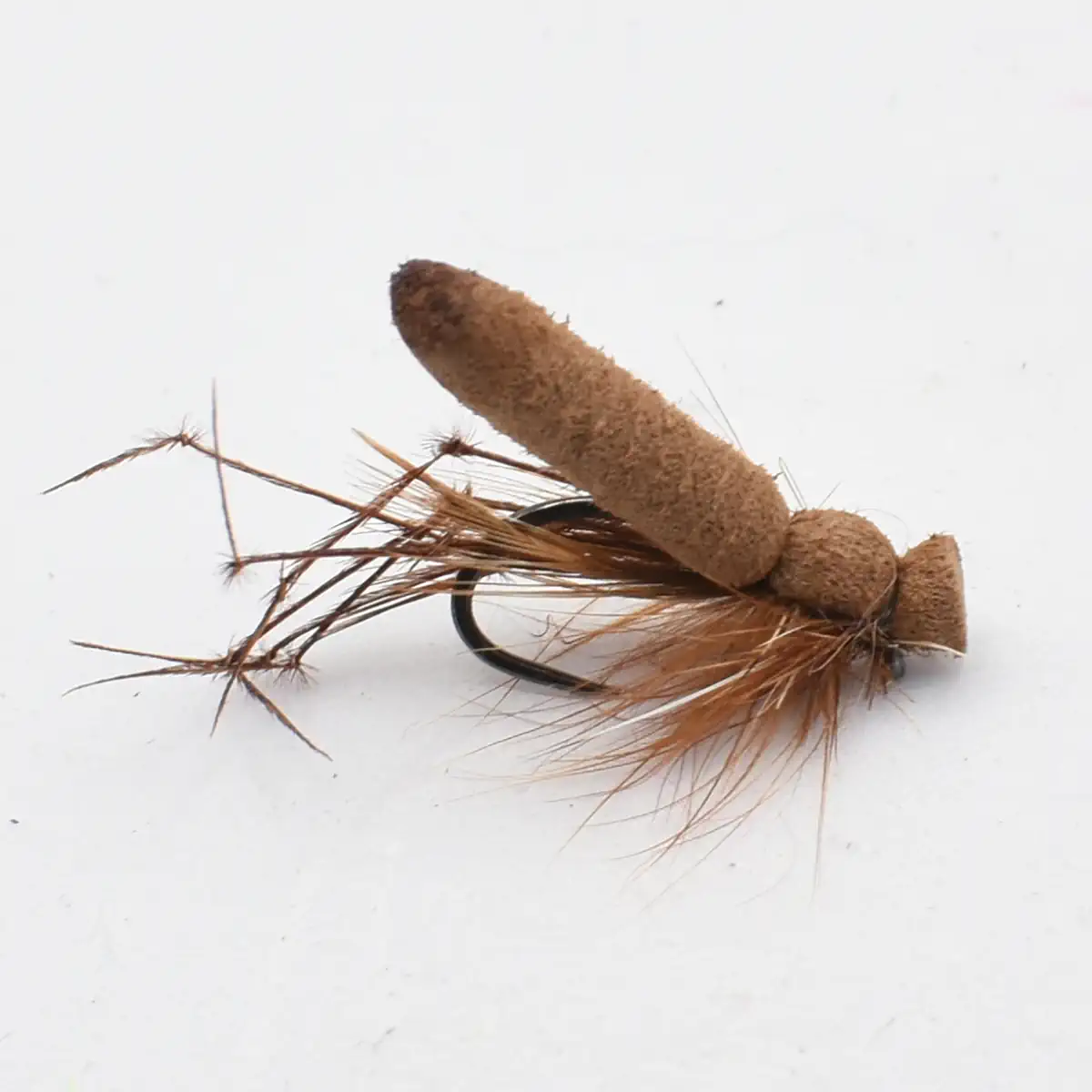 Brown fishing fly lure with a foam body and brown feathered hackle on a black hook (close-up).