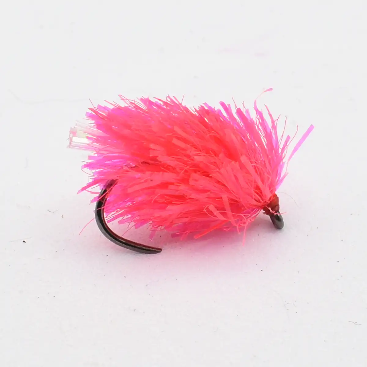 Pink fluffy fishing lure with a sharp curved hook, designed to attract fish