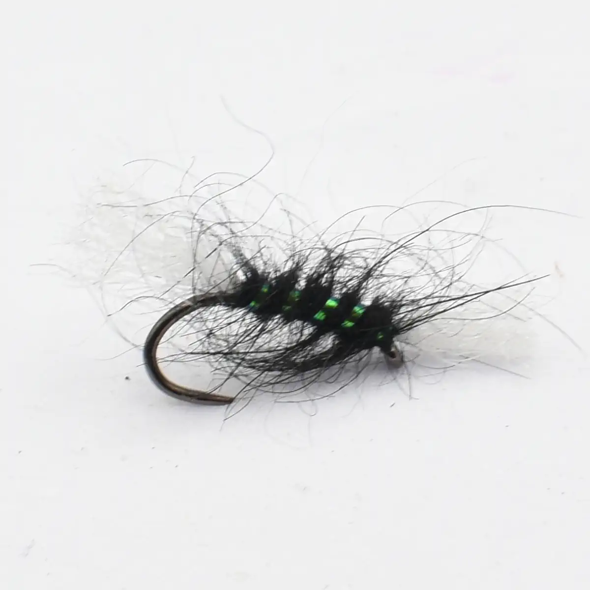 Black fuzzy fishing fly with a curved hook and green bead accents along the body