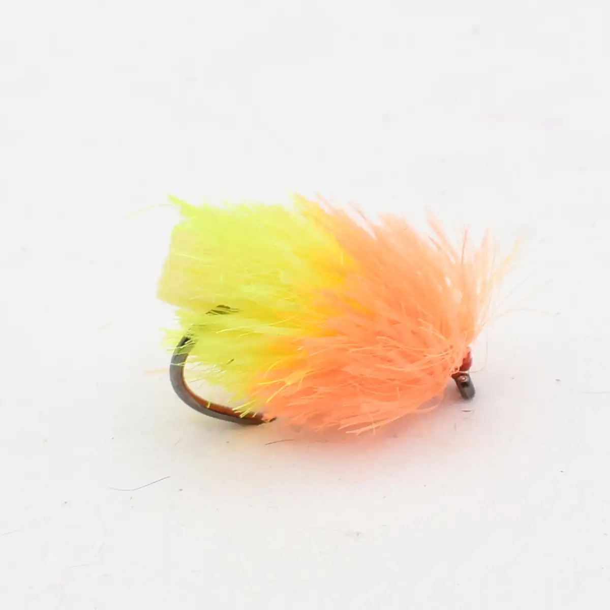 Bright yellow and orange feather fishing fly on a curved hook, used for fly fishing.