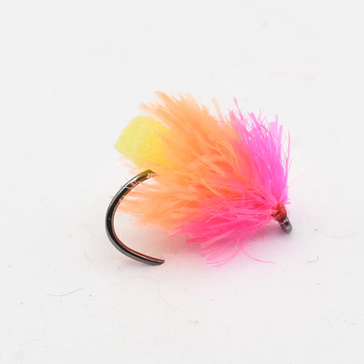 Colorful fishing fly with pink, orange, and yellow feathers on a curved hook.