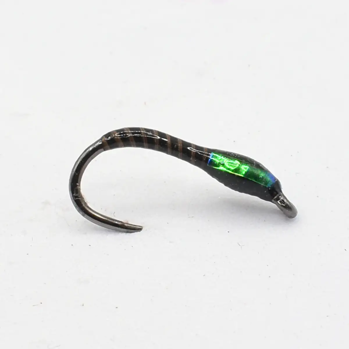 Glow-in-the-dark fishing lure: a curved hook with a small green illuminated capsule inside the body of the lure.