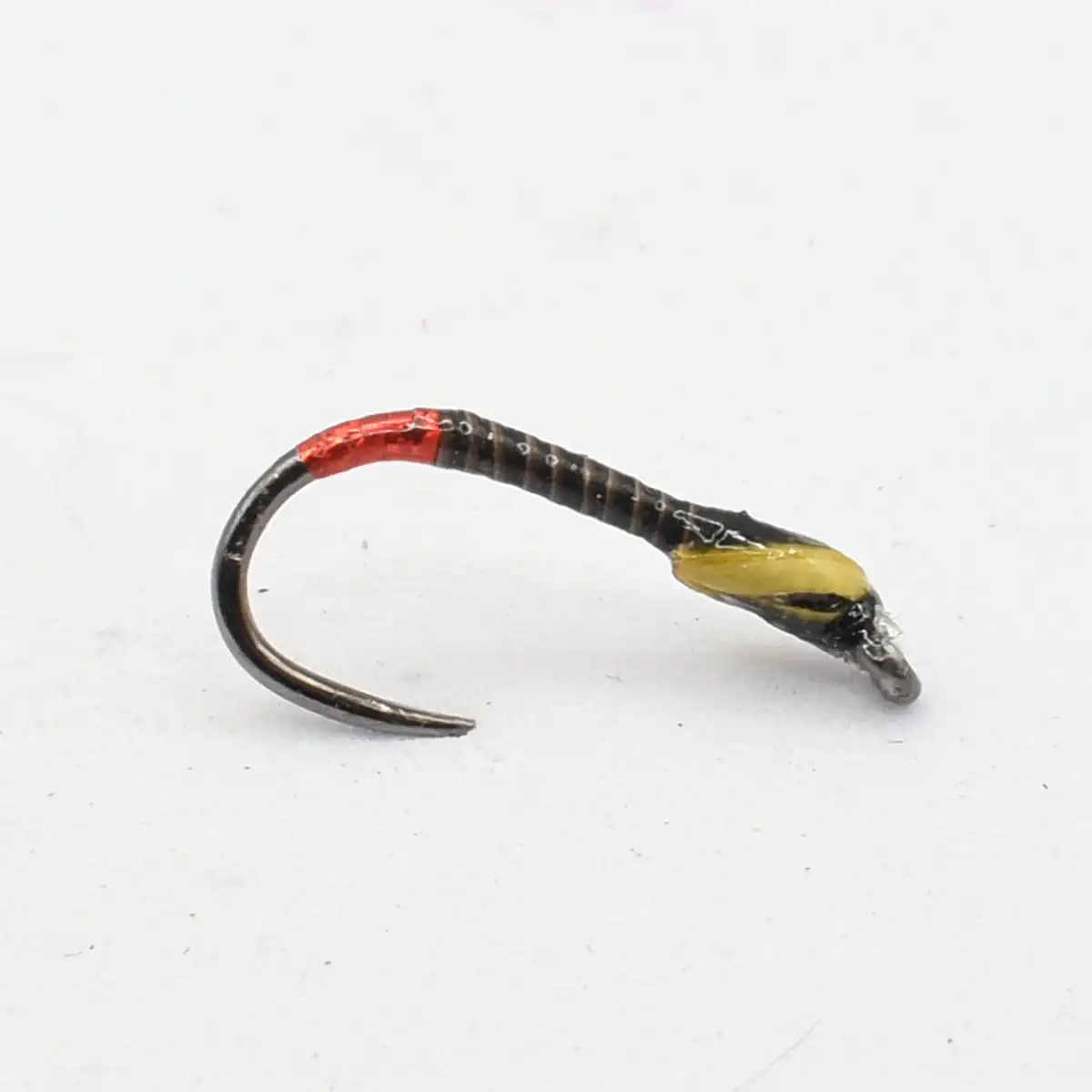 Fishing lure: a curved jig hook with a black body, red head, and a yellow tail.