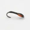 Small fishing hook with a black and red soft plastic lure attached, resting on a white surface.