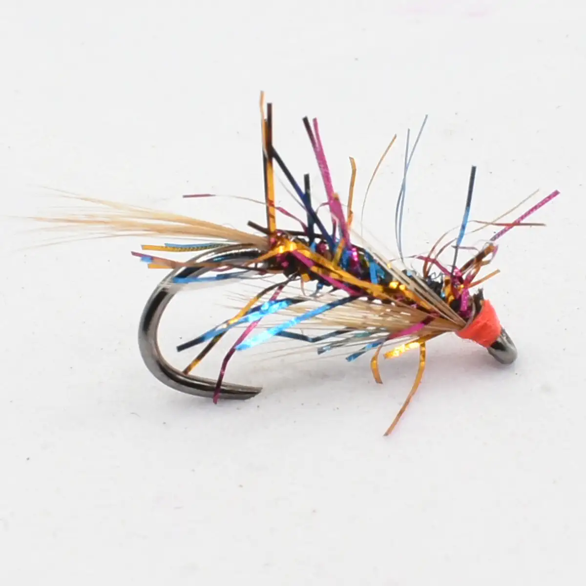 Colorful metallic-tinsel fishing lure tied to a curved hook, used for fly fishing.