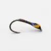 Close-up of a metal fishing hook with a wrapped brown body and a yellow bead near the eye.