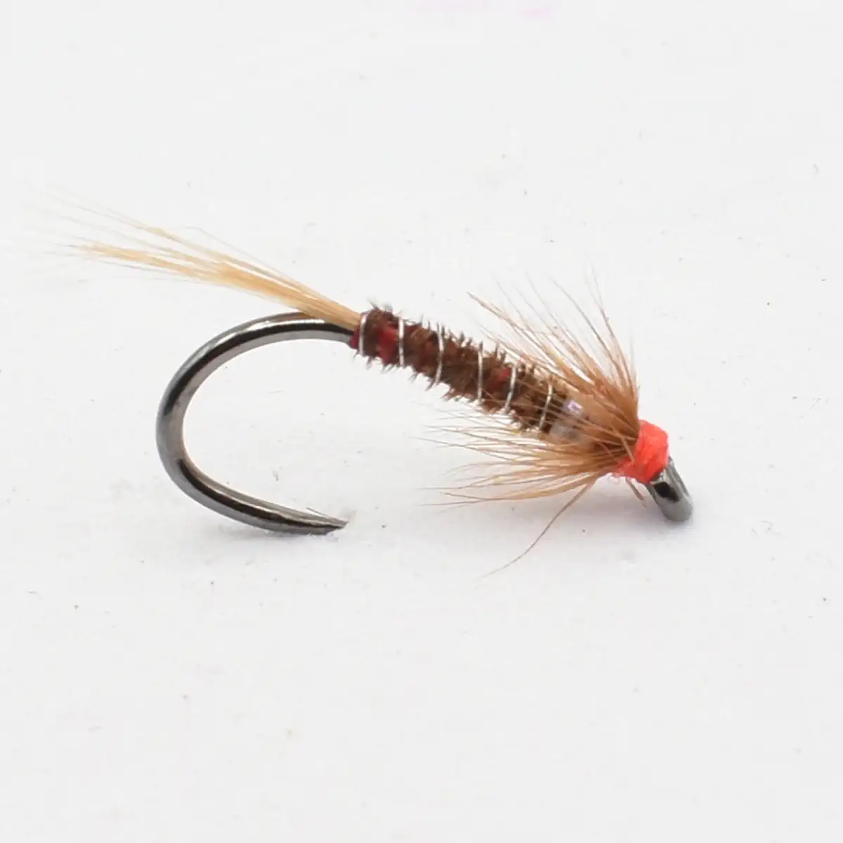Close-up of a fishing fly (artificial lure) with a brown body, light brown hackle, and a bright orange head on a metal hook.