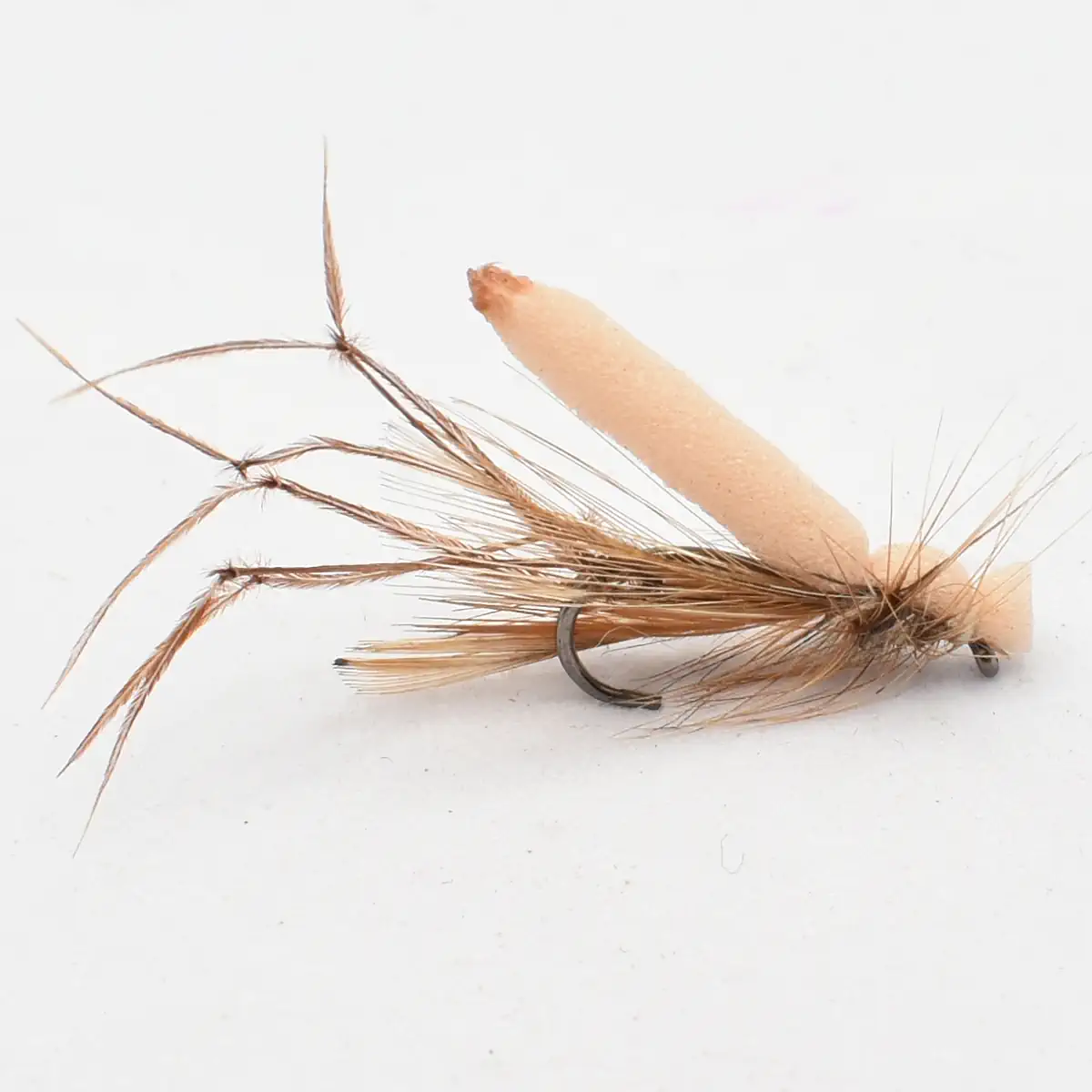 Brown feathered fishing fly with a beige foam body on a curved hook, used in fly fishing.