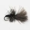 A black/brown fluffy fishing fly with a fuzzy body and feathered hackle on a curved hook, used in fly fishing.