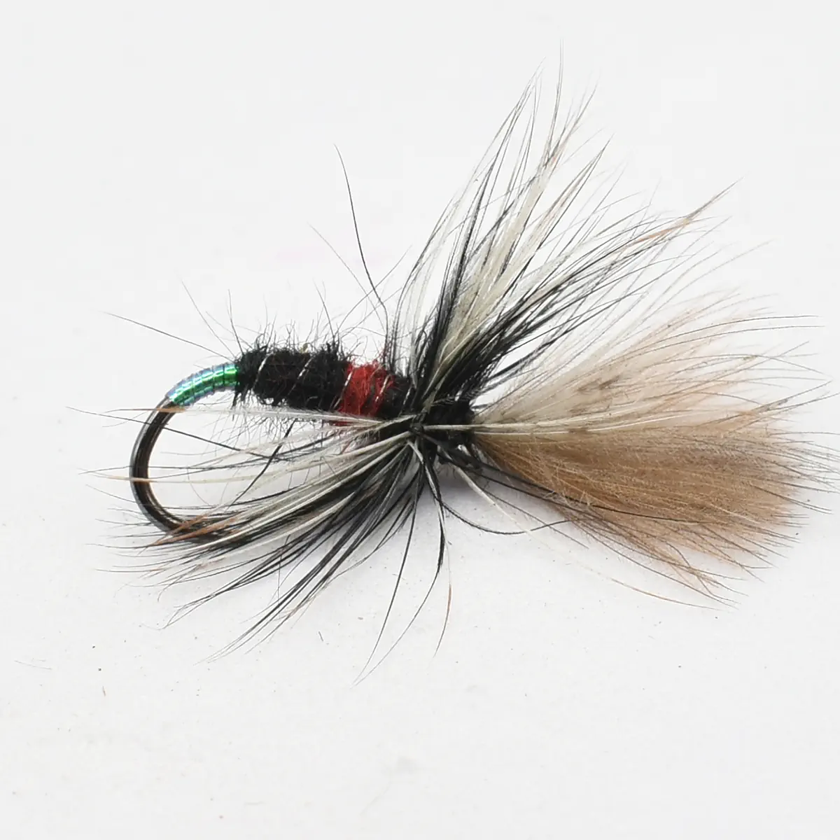 Artificial fishing fly with a black body, red rib, green metallic head, and tan feather tail on a curved hook, used for fly fishing.