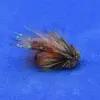 A close-up of a feathered fishing lure with brown, orange, and grey hairs on a blue background.