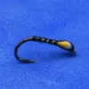 Close-up of a small fishing hook tied with black thread and a yellow bead lure against a blue background.