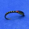 Close-up of a black fishing lure with gold beads along its body on a blue background.