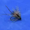 Dry-fly fishing lure with black-gray feather hackle on a metal hook against a blue background
