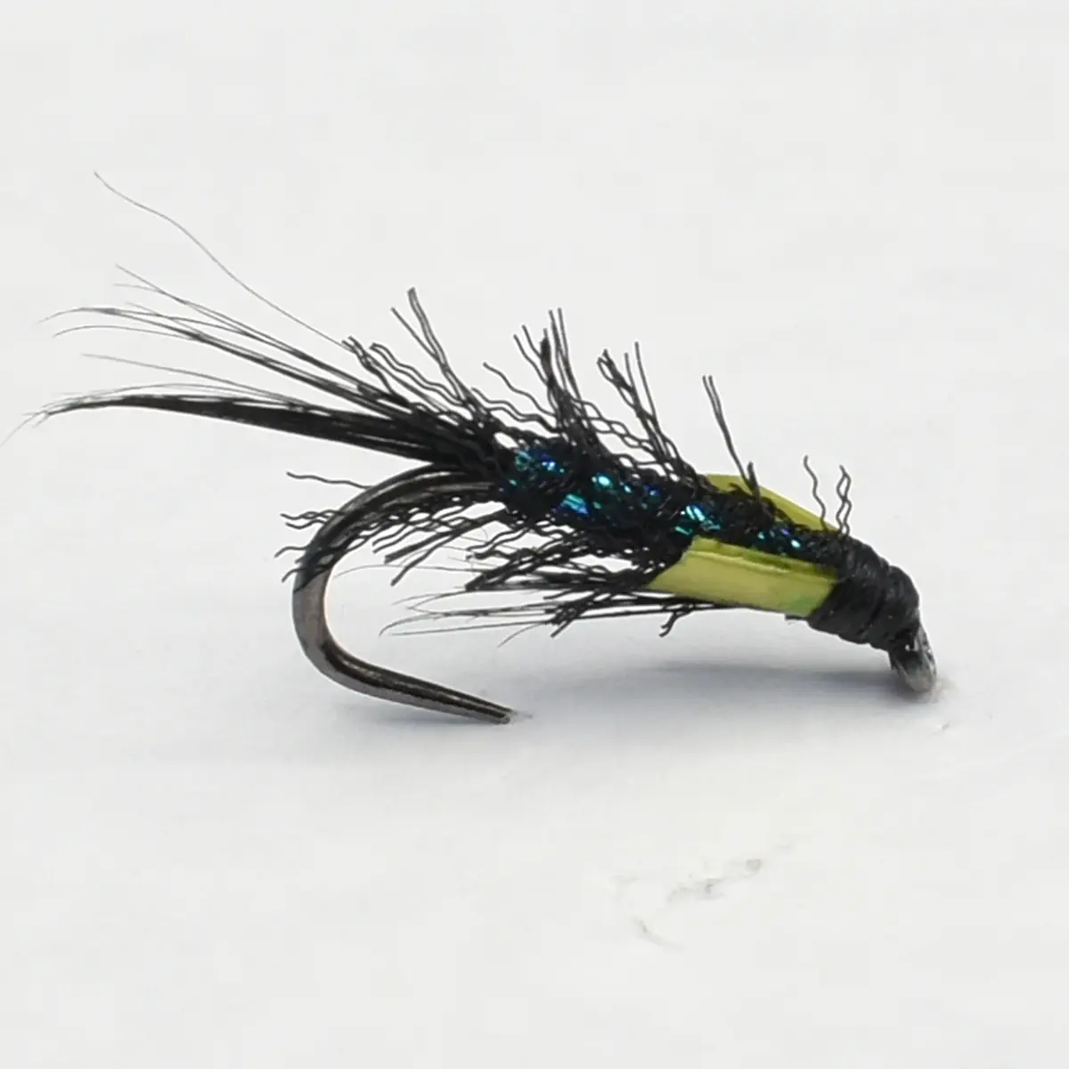 Green and black fishing fly with feathery hackle and blue-green bead accents on a curved hook edge.