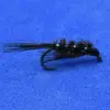 Bead-headed black woolly bugger fly with marabou tail and green beads on a blue background