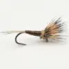 Close-up of a brown and tan fishing fly tied to a hook, with feather hackle and thread-wrapped body.