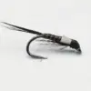 Close-up of a fishing fly tied to a curved hook, with a dark brown segmented body and wispy black feathers extending from the rear.