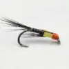 Bead-head fishing fly with yellow body, orange head, and long black tail feathers on a hook.