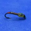 Close-up of a small fishing lure with a curved hook and segmented brown body on a blue fabric background.