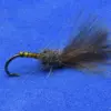 A fishing fly lure with a dark fuzzy tail and striped yellow-brown body on a curved hook, used for fly fishing.