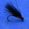 Black feathered fishing fly tied on a curved hook with a red body, set on a blue background for trout fishing.