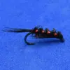 A black and red fishing fly with copper ribbing on a curved hook, resting on a blue background.