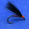 Black hackle dry fly with orange thread body mounted on a curved fishing hook against a blue background.
