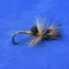 A fishing fly with light brown and gray hackle tied to a curved hook on a blue background.