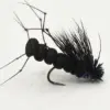 Close-up of a black fly fishing lure with a segmented body and wispy feather tail on a curved hook.