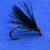 Black feathered fishing fly with a red bead head mounted on a curved hook, set against a blue background (trout fishing lure).