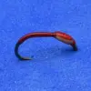 Red soft-plastic fishing lure shaped like a curved worm with a black hook end on a blue background