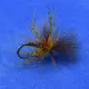 Close-up of a colorful fishing fly with yellow, orange, and brown hackle fibers tied to a curved hook, used as an artificial lure for fly fishing.