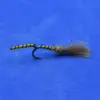 Bead-headed olive green fly fishing lure with fur tail resting on a blue background, hook visible.